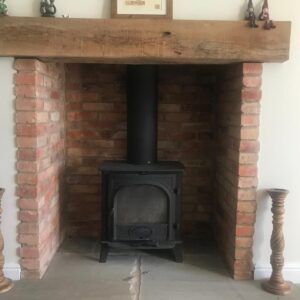 Solid oak fireplace mantle in home.