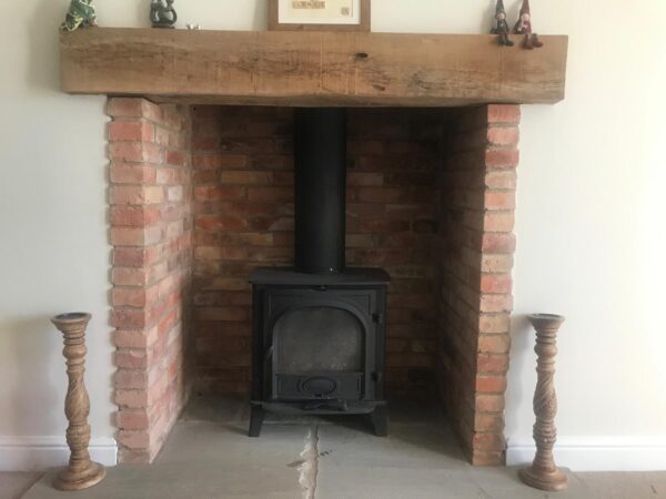 Solid oak fireplace mantle in home.